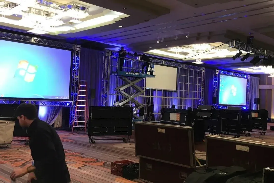 PTES technician setting AV for a ballroom general session